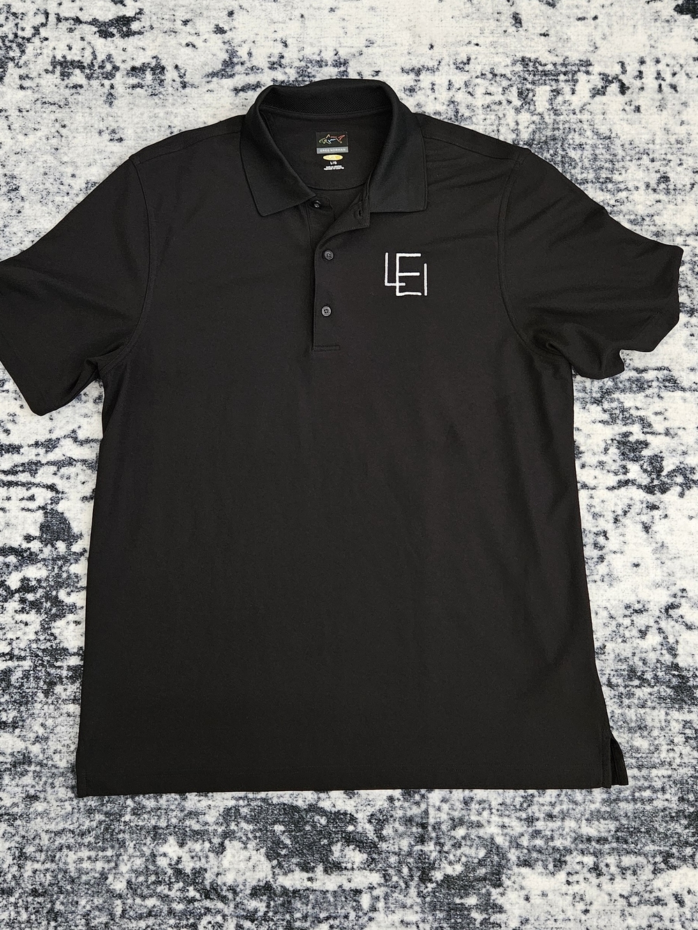Greg Norman Collection Black Polo with LEI Embroidered Logo